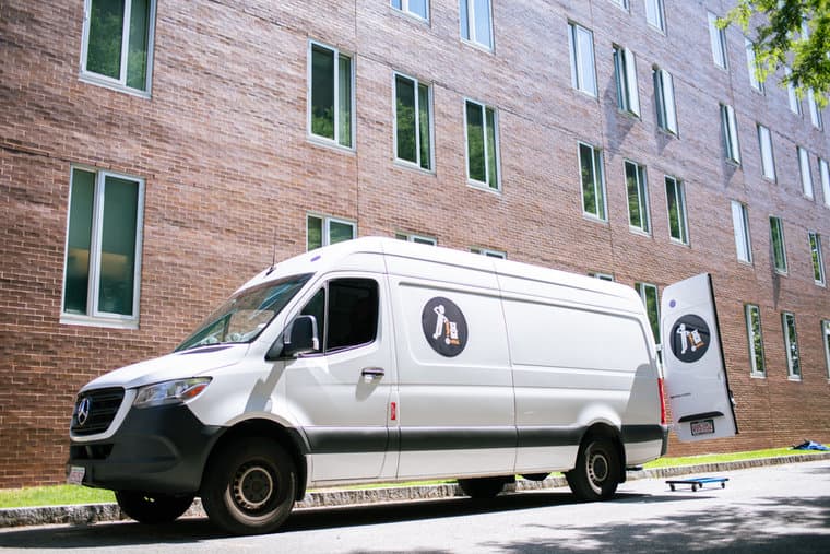 A Small Haul van parked beside a brick building in Boulder
